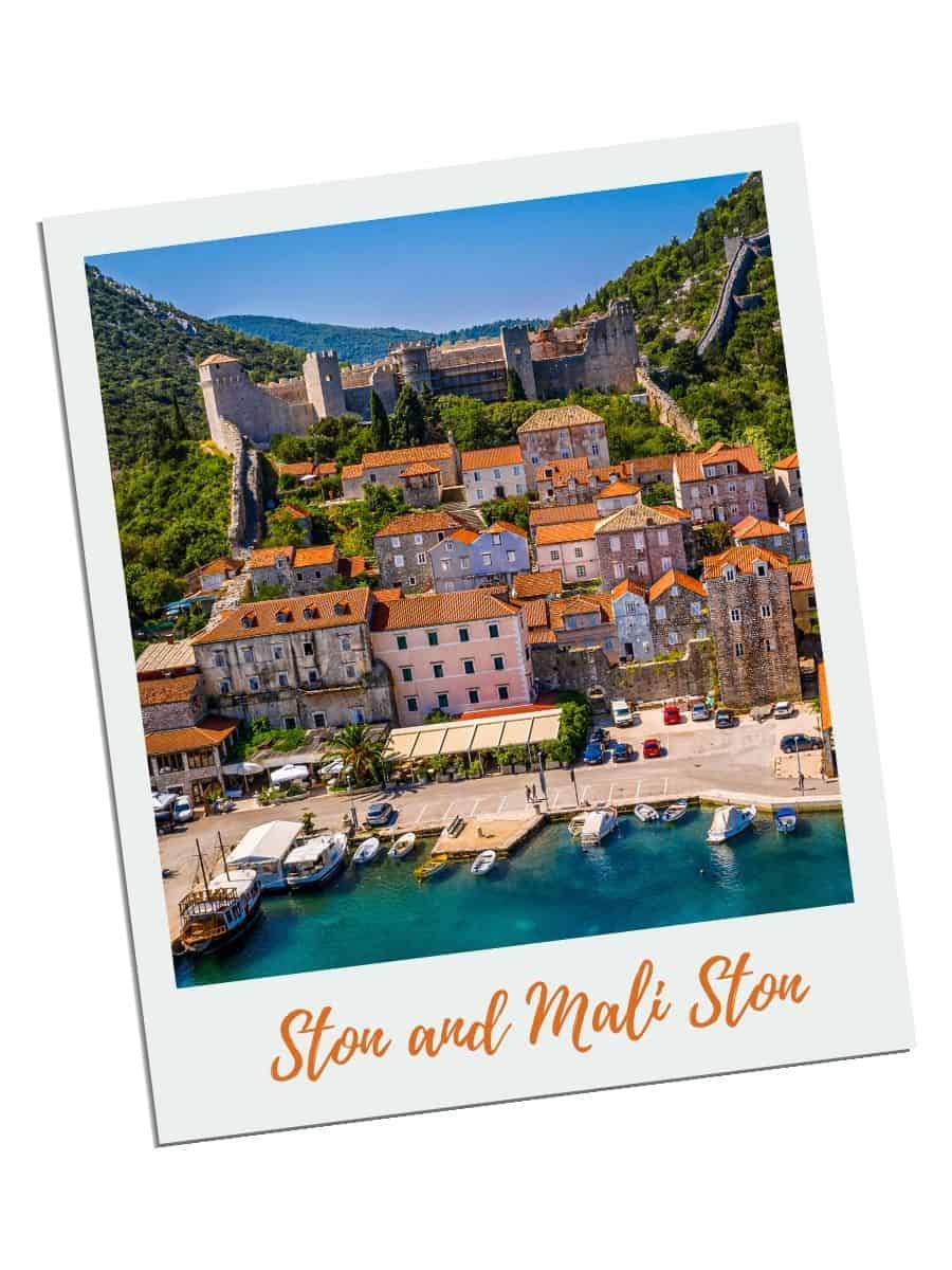 Aerial view of Ston and Mali Ston historic walled town with ancient fortifications and terracotta roofs overlooking turquoise harbor, popular day trip destination from Dubrovnik, Croatia