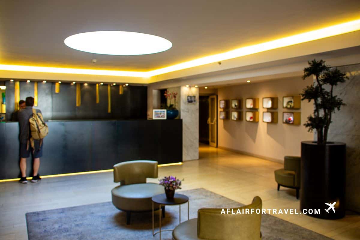 Contemporary hotel lobby reception area at Mandarin Oriental Prague with ambient lighting, modern seating, and art displays