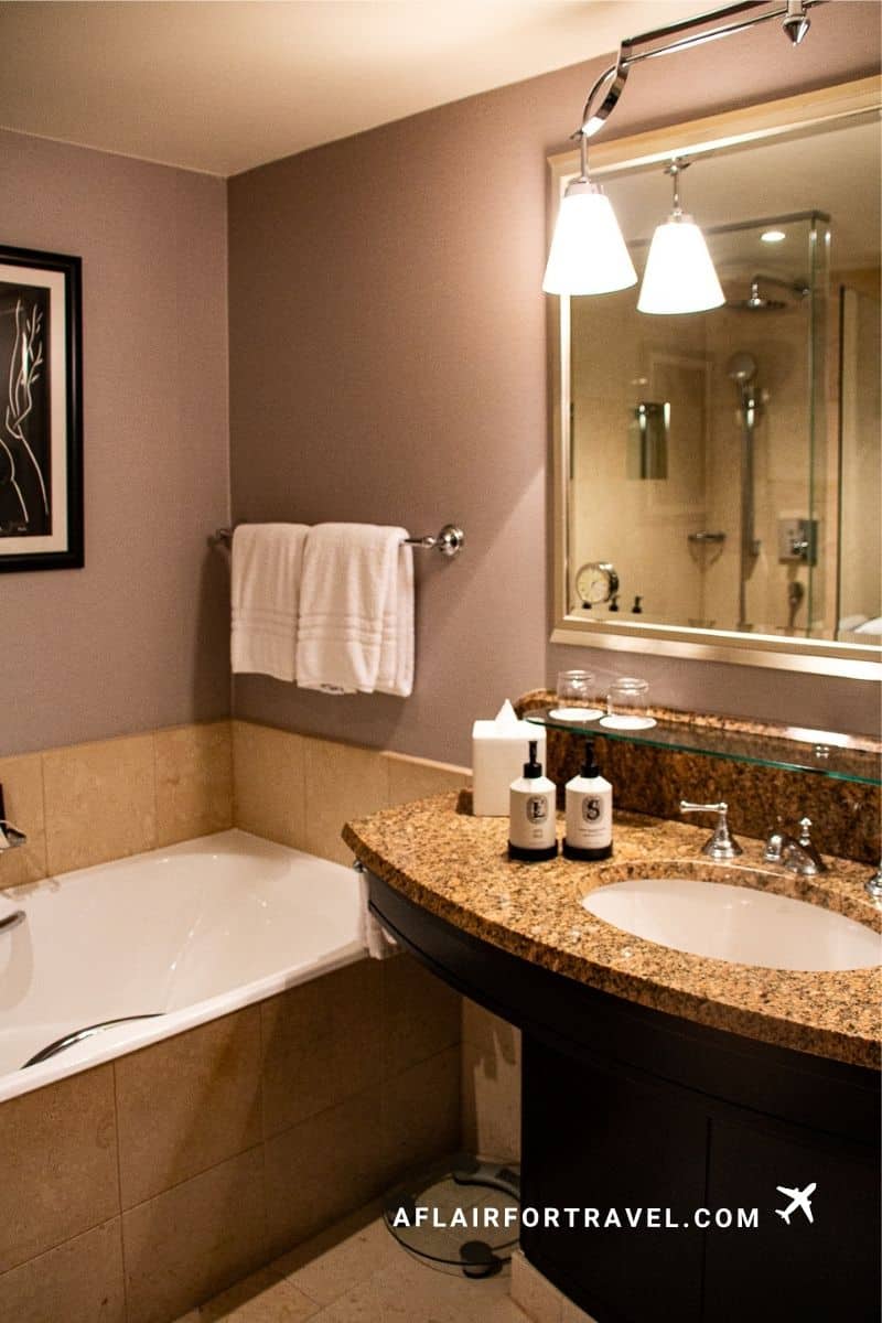 Four Seasons Prague bathroom with granite vanity, bathtub, and warm lighting