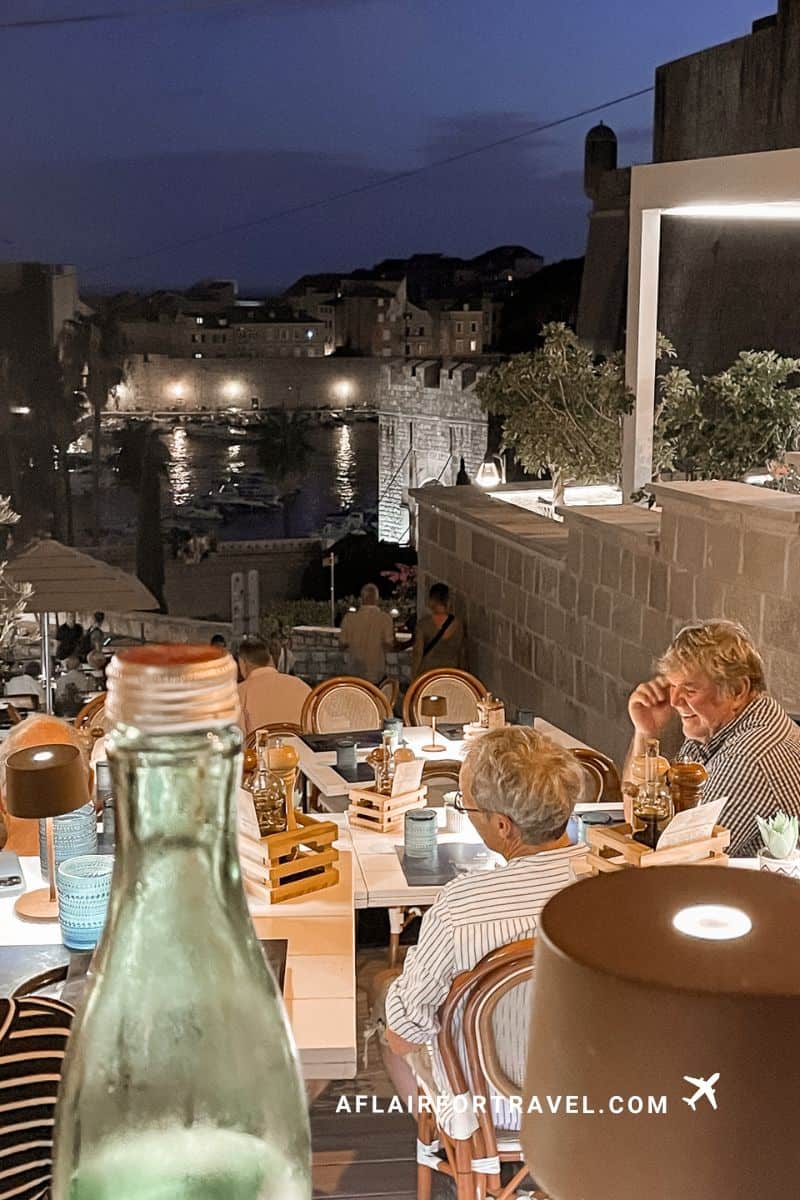 Kenova Restaurant Dubrovnik terrace with harbor view at night, diners enjoying illuminated old port atmosphere
