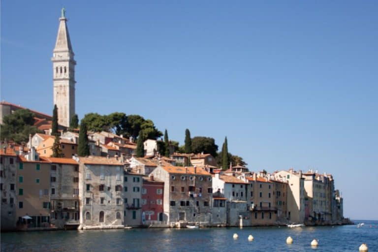 Historic waterfront in Rovinj with colorful stone houses and the bell tower overlooking the Adriatic Sea