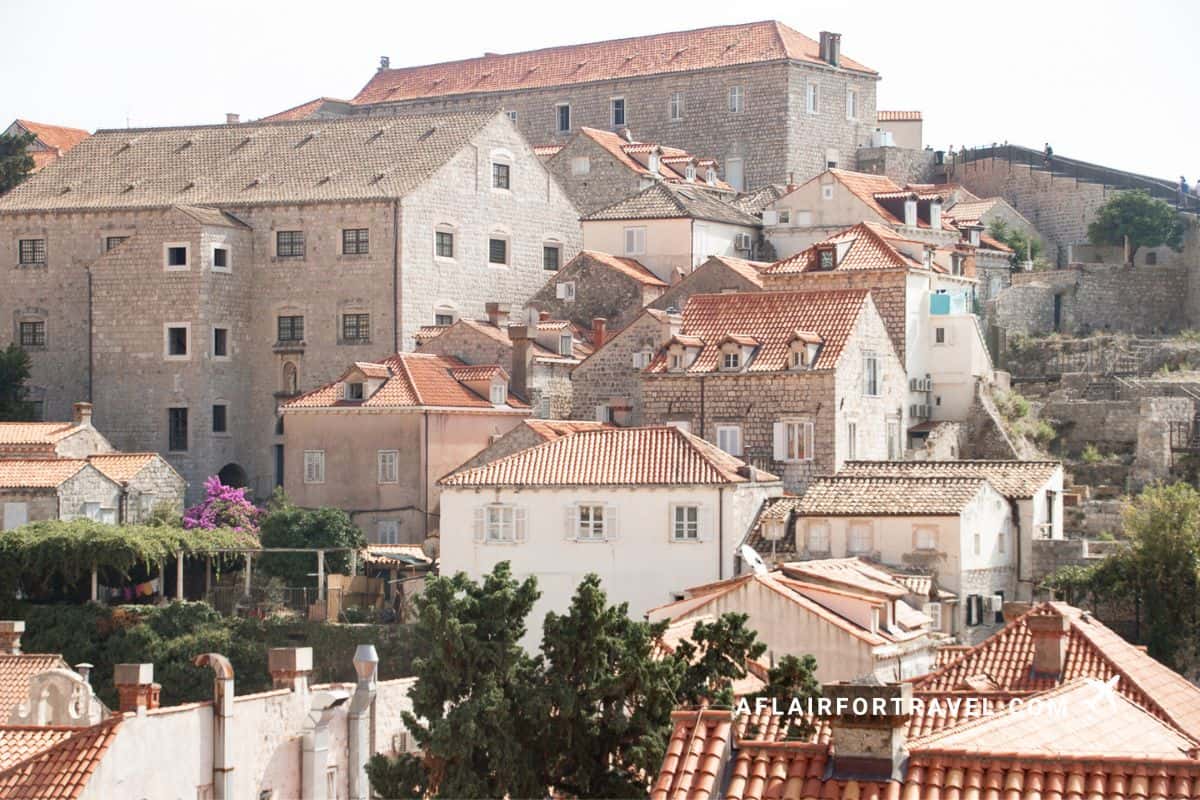 Layered terracotta rooftops and limestone stone buildings cascading up the hillside in Dubrovnik, with touches of bougainvillea and medieval architecture make visiting Croatia worth it