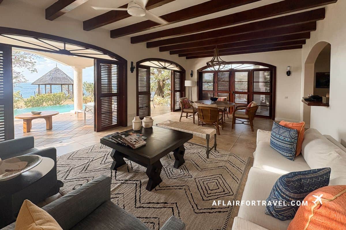 Spacious villa living room at with exposed beam ceiling, arched doorways, ocean views, and private infinity pool deck is one of the top reasons to stay at Cap Maison St. Lucia