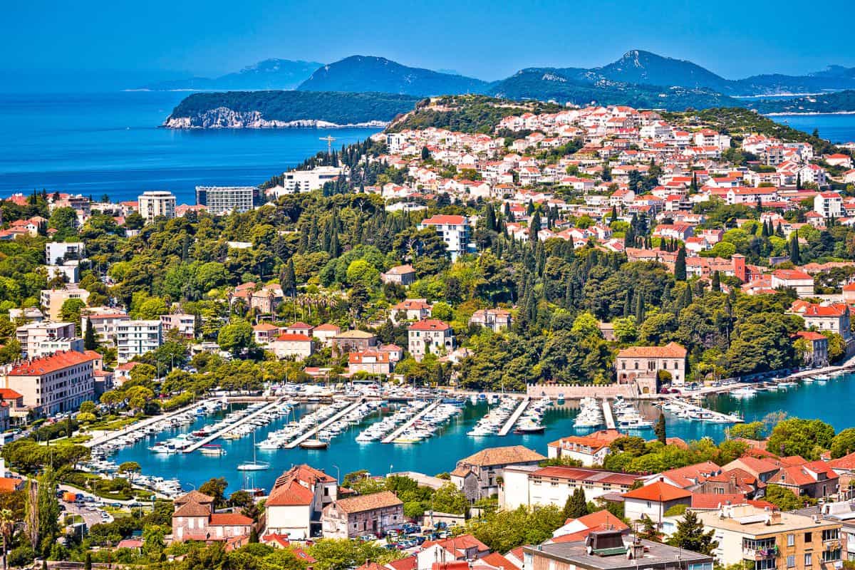 Aerial view of Babin Kuk neighborhood showing where to stay in Dubrovnik outside Old Town, with marina, terracotta roofs, and Adriatic islands in background