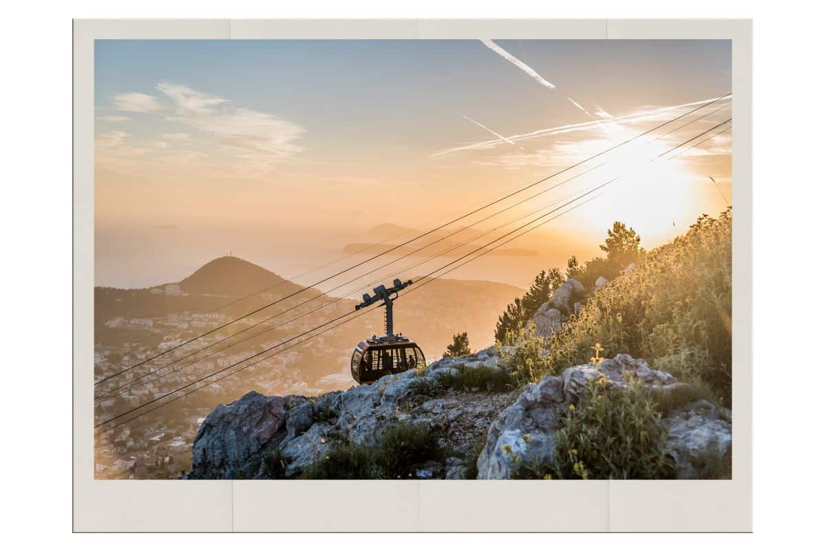 Dubrovnik cable car ascending Mount Srđ at golden hour with sweeping panoramic views of the city, Adriatic Sea, and surrounding islands, a must-do experience on a 3-day Dubrovnik itinerary