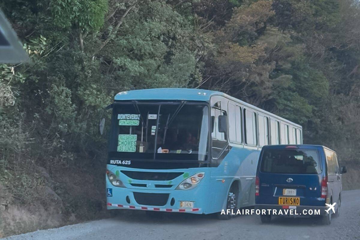 Bus navigating a narrow mountain road in Costa Rica, highlighting challenging driving conditions. A common Costa Rica travel mistake is not realizing that you need to drive defensively.