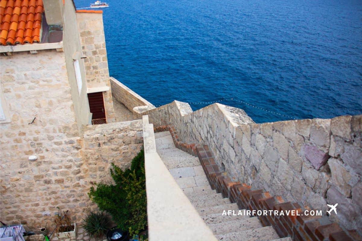 Steep, narrow, stone staircase along Dubrovnik’s medieval city walls leading down toward the sea