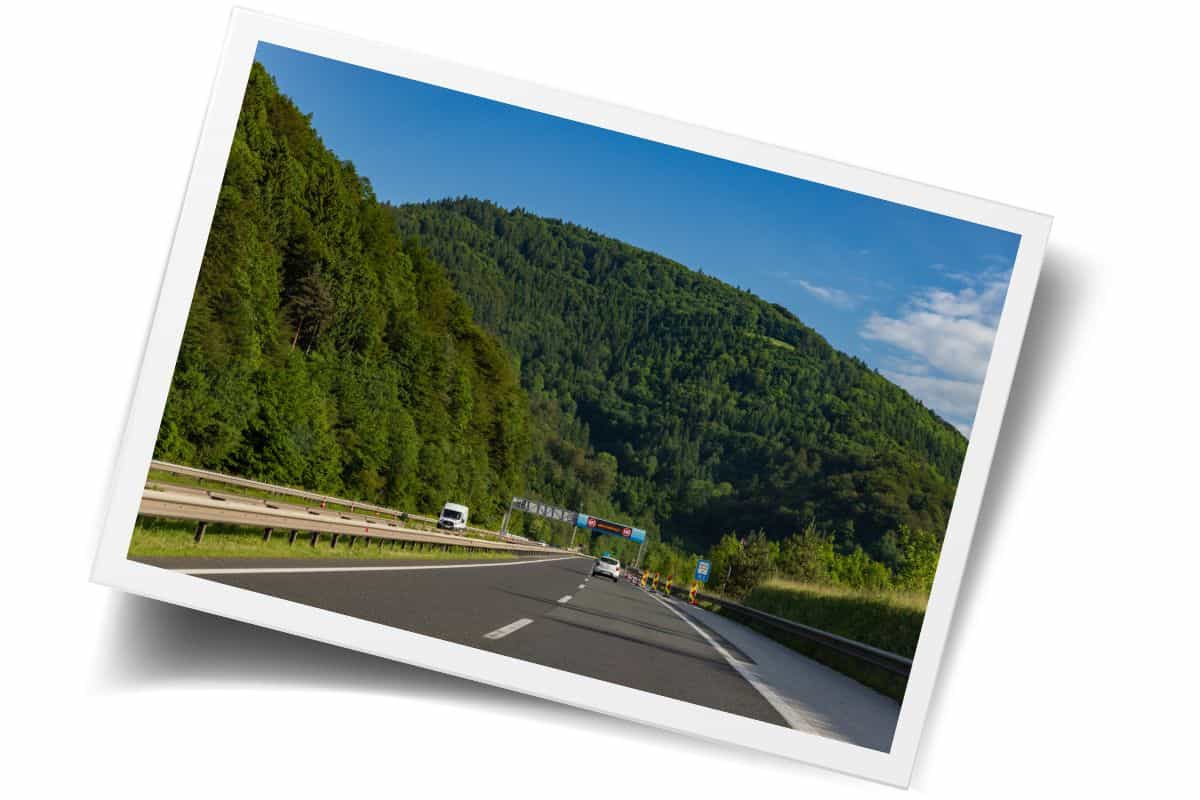 Scenic drive through lush green mountains in Slovenia. If you're planning a trip to Slovenia, car rentals offer flexibility.