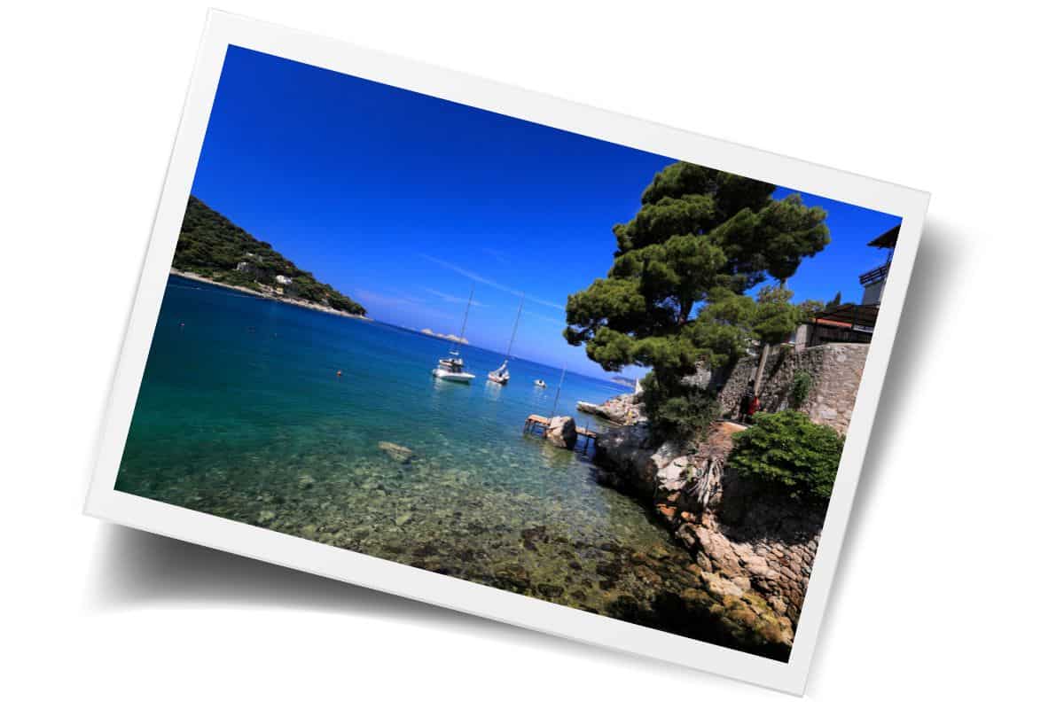 Crystal clear turquoise waters and sailboats anchored in Lapad Bay, a peaceful coastal escape to discover on a 3-day Dubrovnik itinerary