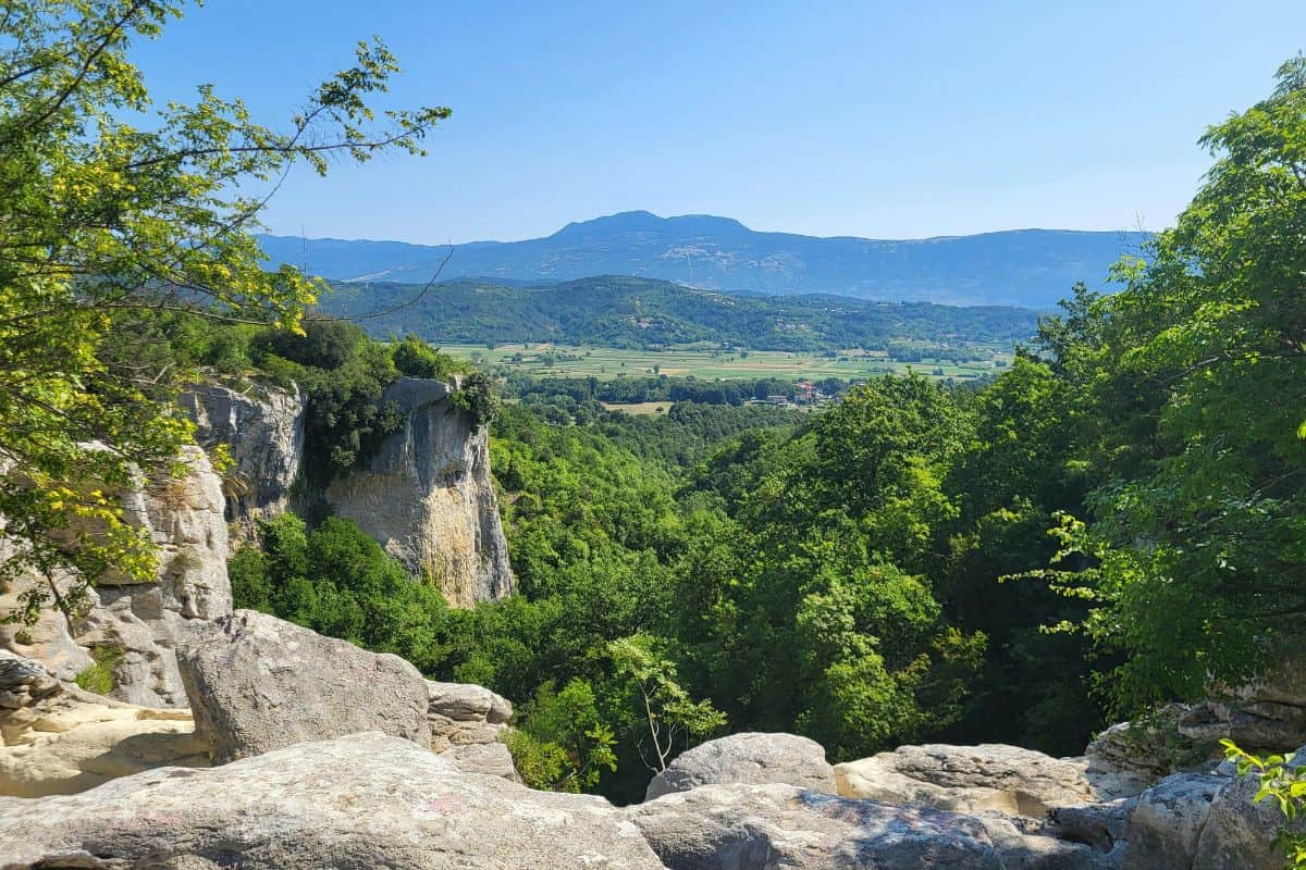 Sweeping views of Croatia's lush green inland landscape with rocky outcrops, forested valleys and mountain peaks