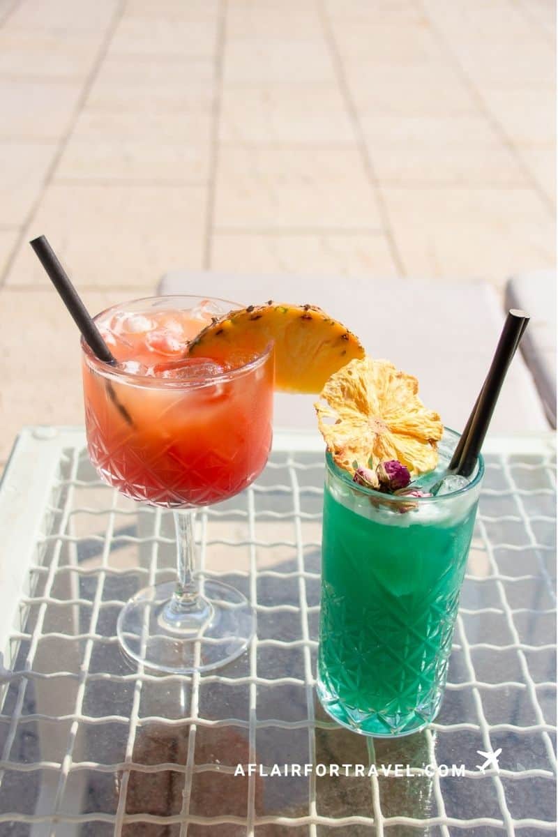 Two colorful cocktails served at a Croatian restaurant, enjoyed responsibly in designated areas rather than on residential streets