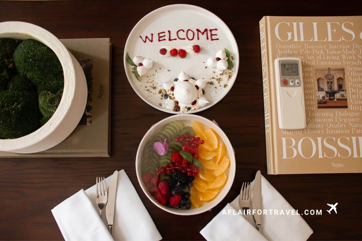 A welcome dessert plate decorated with berry writing and meringues alongside a fresh fruit bowl at Boutique Hotel Stari Grad Dubrovnik, one of the top boutique hotels in Croatia.