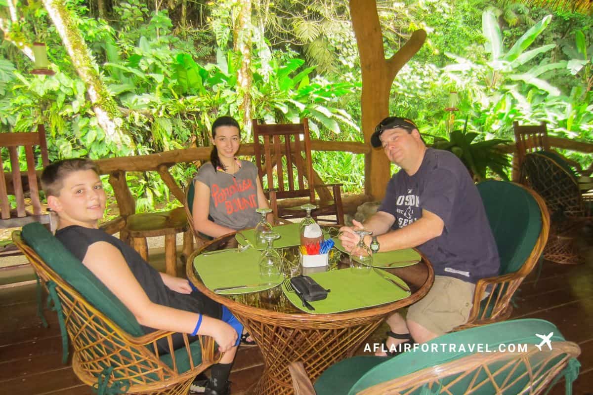 A family enjoying an open-air dinner surrounded by lush rainforest in Costa Rica