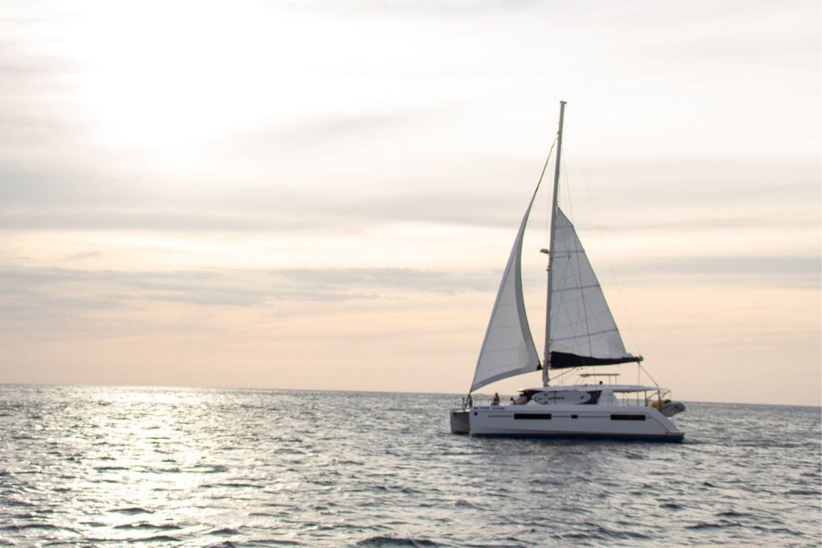 Catamaran sailing off the coast of Costa Rica at sunset, a popular family-friendly excursion