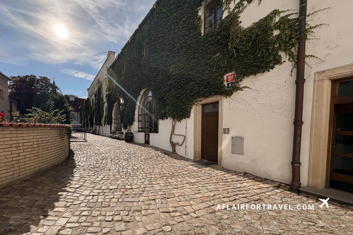 Ivy-covered building along a quiet cobblestone lane in Mala Strana, a peaceful corner worth seeking out