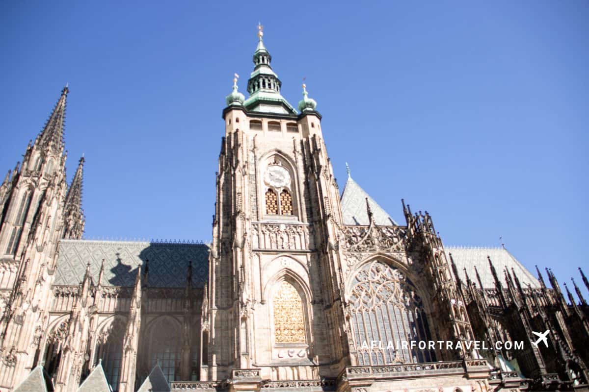 St. Vitus Cathedral's Gothic tower and clock face rising above Prague Castle