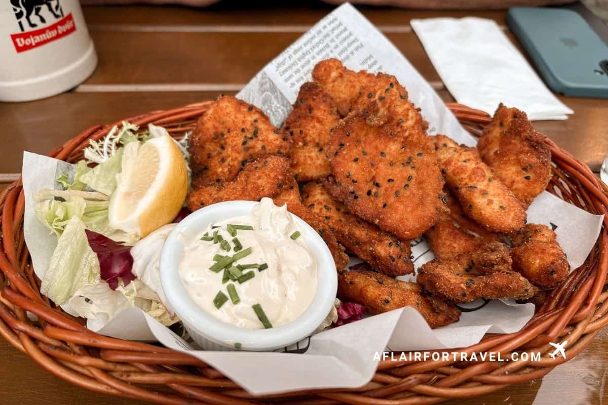 Basket of scnitzel with tartar sauce and lemon, a Czech pub classic