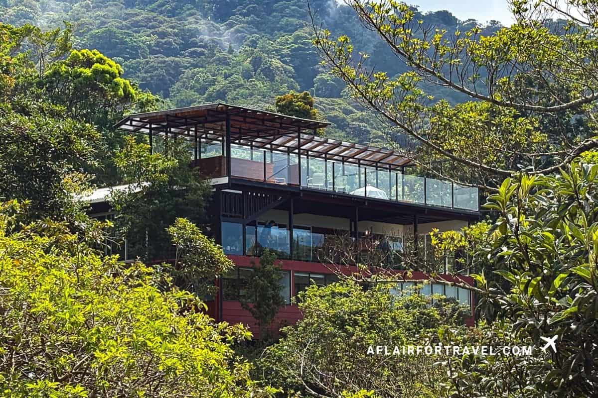 Modern glass and wood hotel building rising above the treeline in Monteverde Costa Rica