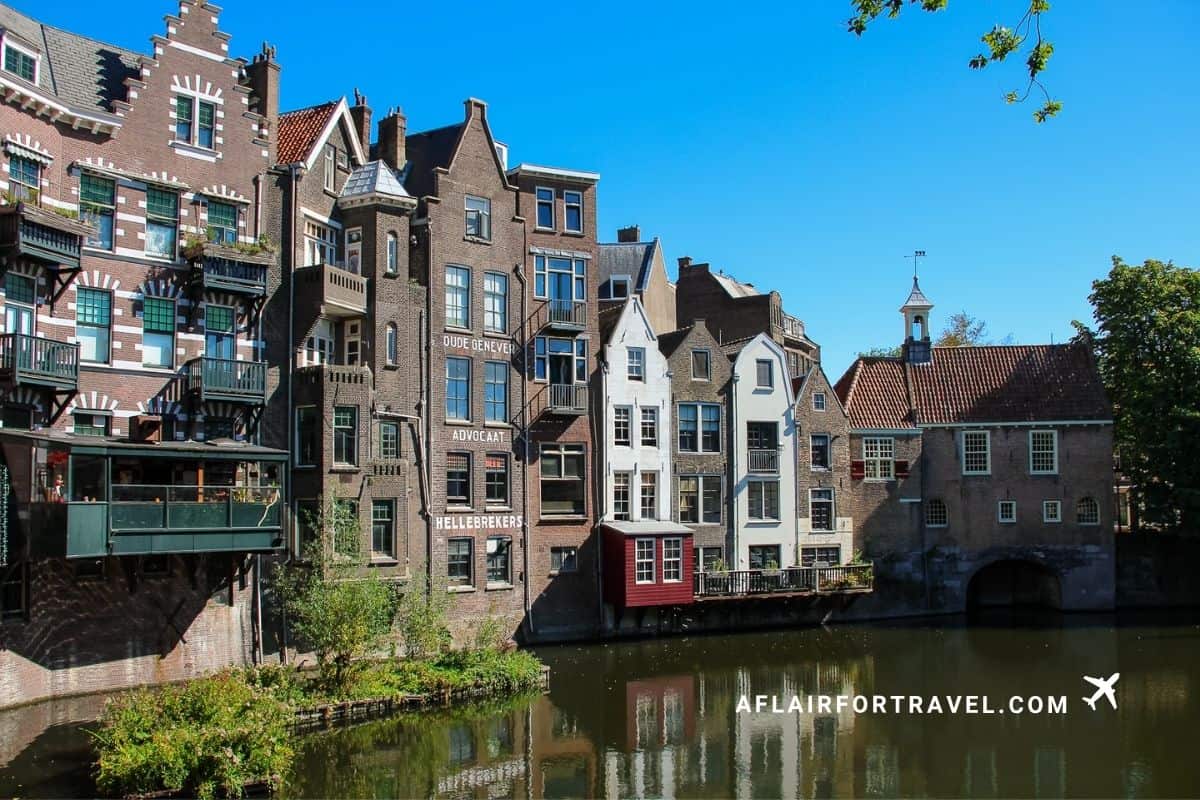 Traditional Dutch buildings with painted signage lining a canal in Rotterdam