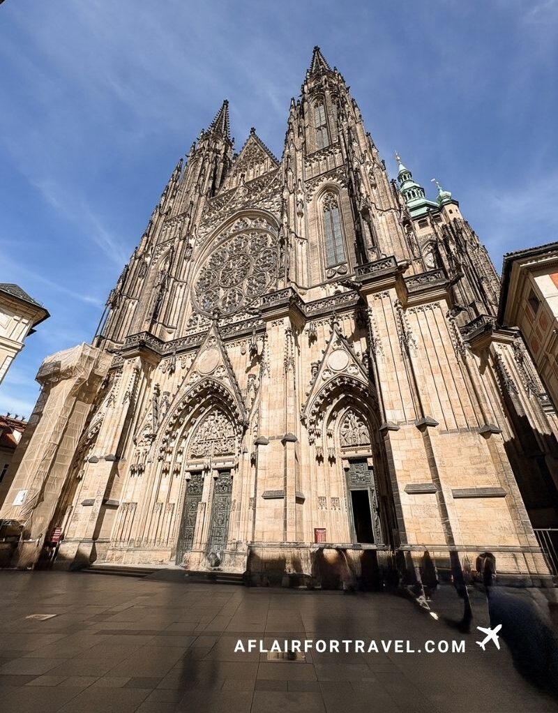 St. Vitus Cathedral's twin Gothic spires against a clear blue sky, Prague