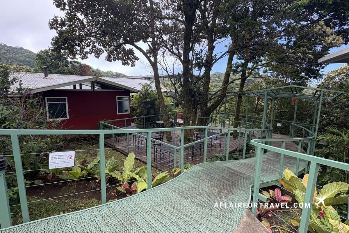 Outdoor deck and walkway connecting cabins at a hillside lodge in Monteverde Costa Rica