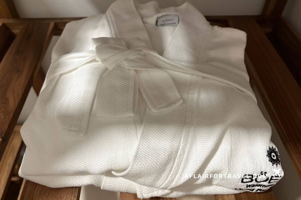 Folded white cotton robe with embroidered logo, a plush amenity at this Monteverde Costa Rica hotel