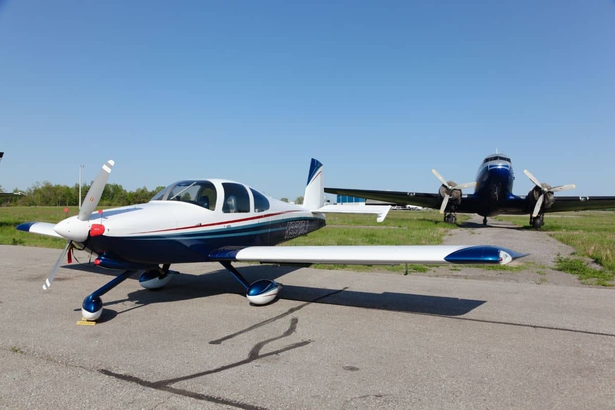 A small private aircraft parked on a runway tarmac
