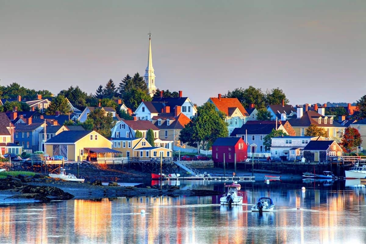 Portsmouth harbor at sunset with boats reflected in calm water, New Hampshire in the fall