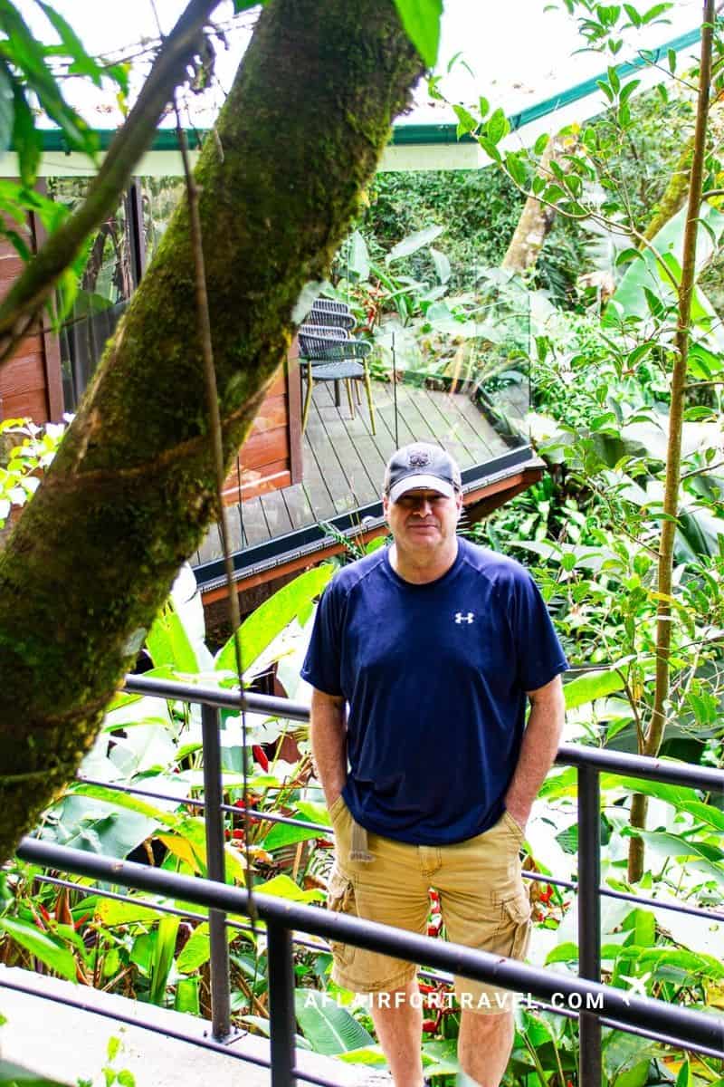 Guest standing on a private balcony overlooking lush gardens at a Monteverde Costa Rica hotel