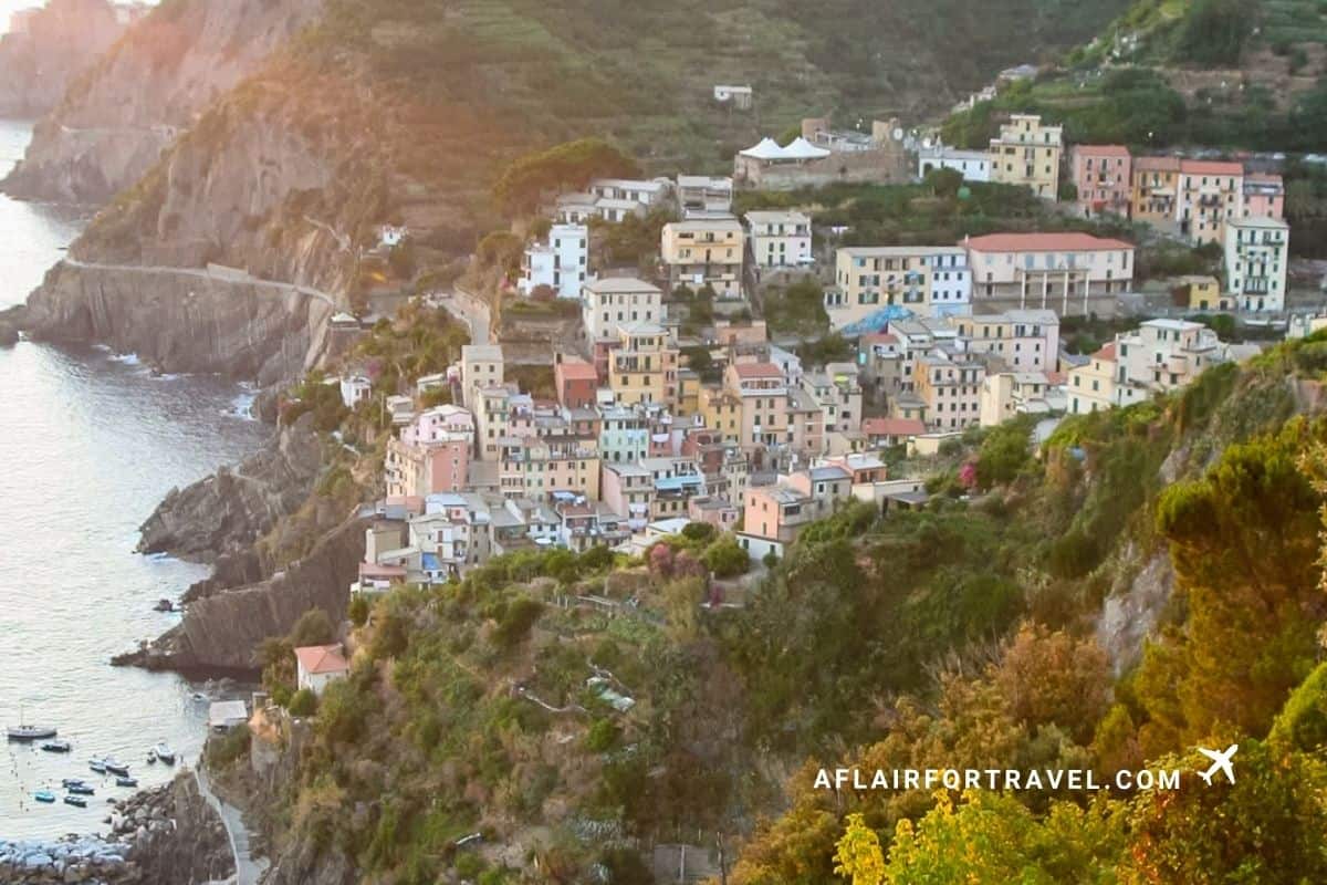 Colorful cliffside houses of Riomaggiore glowing at sunset in Cinque Terre, Italy