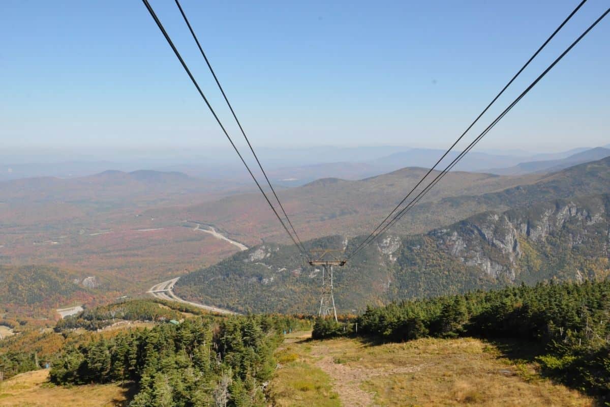 Cannon Mountain aerial tramway cables descending over fall foliage in the White Mountains of New Hampshire