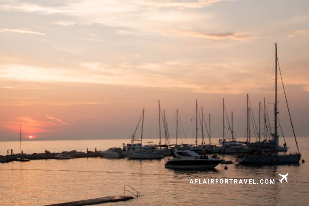 Sunset over a marina filled with sailboats on the Croatian coast in Novigrad