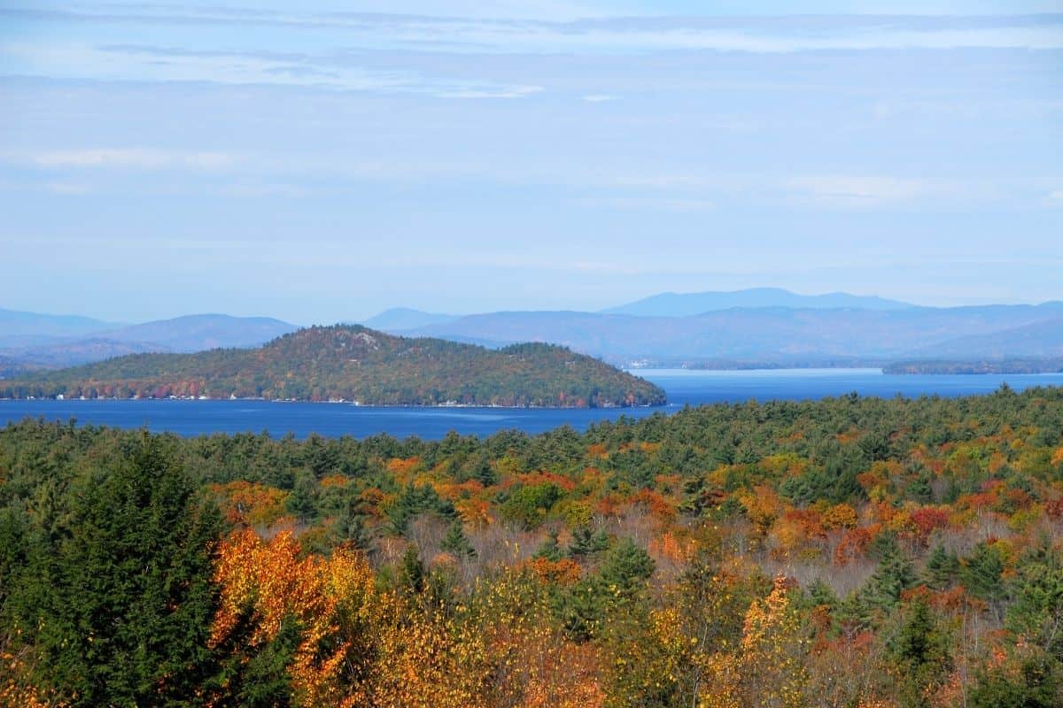 Overlook of Lake Winnipesaukee surrounded by colorful foliage in New Hampshire's Lakes Region