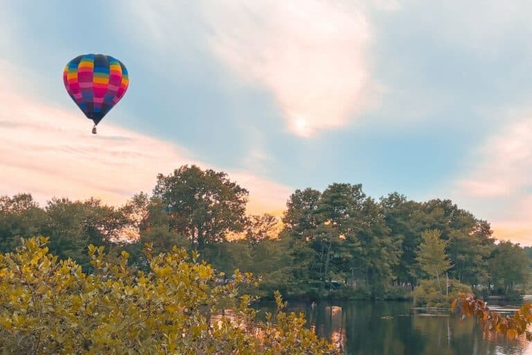 Hot air balloon over a New Hampshire lake at sunrise, one of the state's popular fall activities