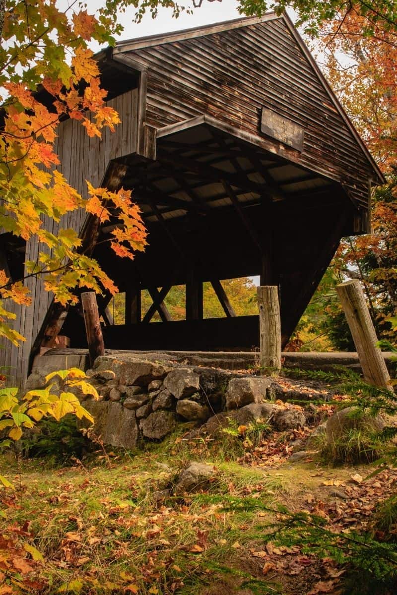 Albany Covered Bridge with a stone abutment in the White Mountains in the fall