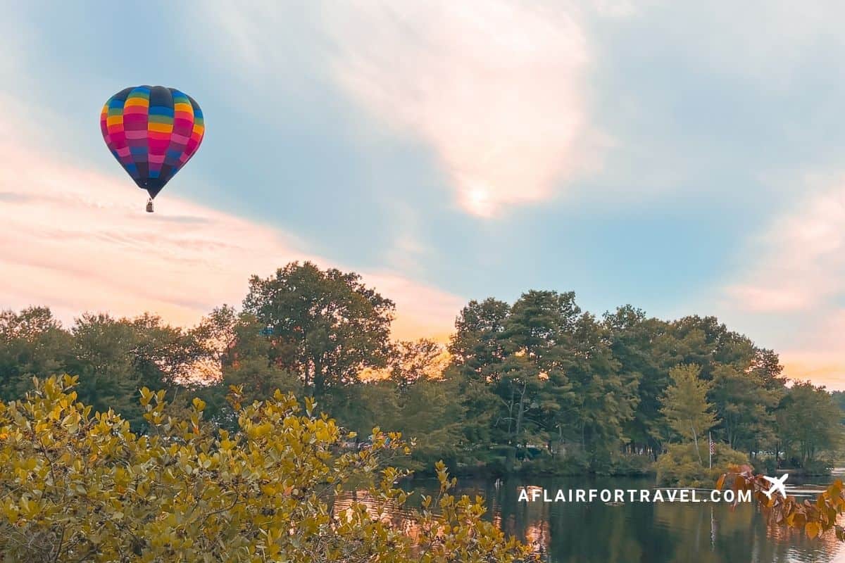 Hot air balloon over a New Hampshire lake at sunrise, one of the state's popular fall activities