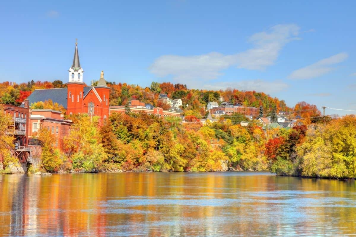 Berlin, New Hampshire during autumn surrounding a scenic river and historic town.