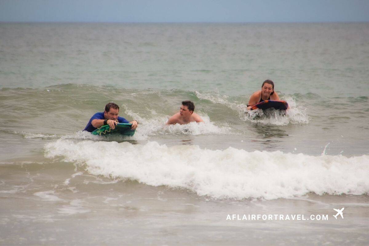 Family bodyboarding in the waves off a Guanacaste, Costa Rica beach