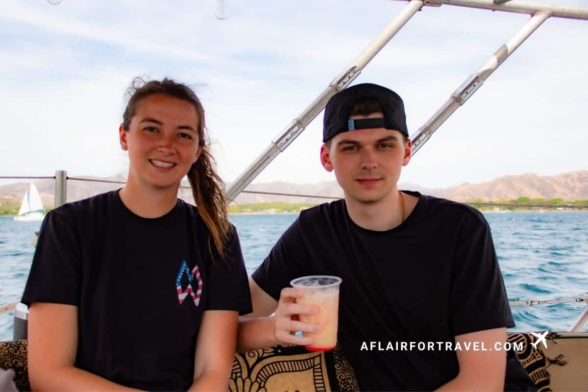 Two travelers enjoying drinks on a sunset boat cruise off the coast of Guanacaste, Costa Rica