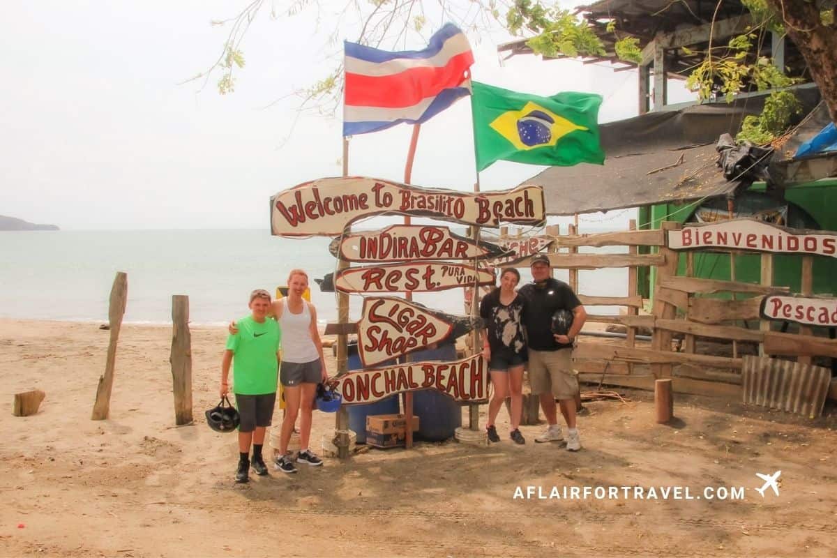 Family at the Welcome to Brasilito Beach sign in Guanacaste, Costa Rica