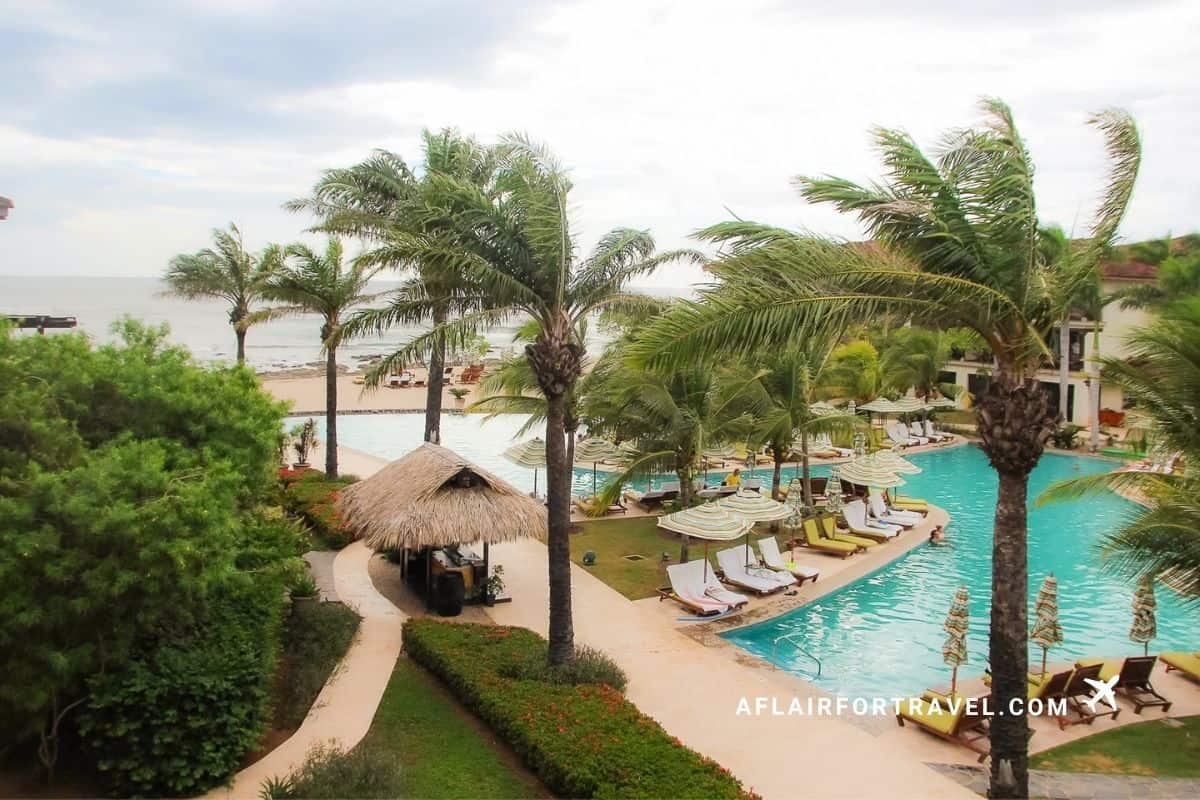 Aerial view of the resort pool, beach, and palm trees at a Guanacaste, Costa Rica resort