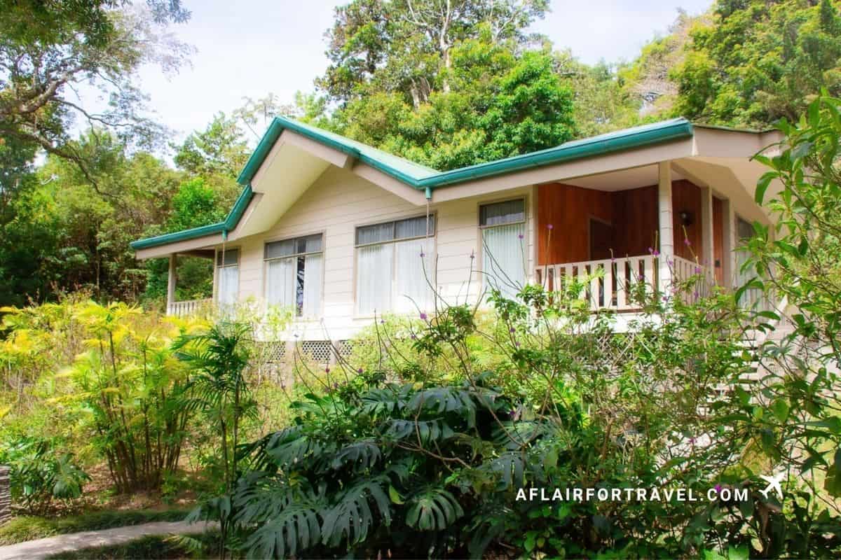 Jungle lodge cottage with a green metal roof tucked into the rainforest near Monteverde, Costa Rica