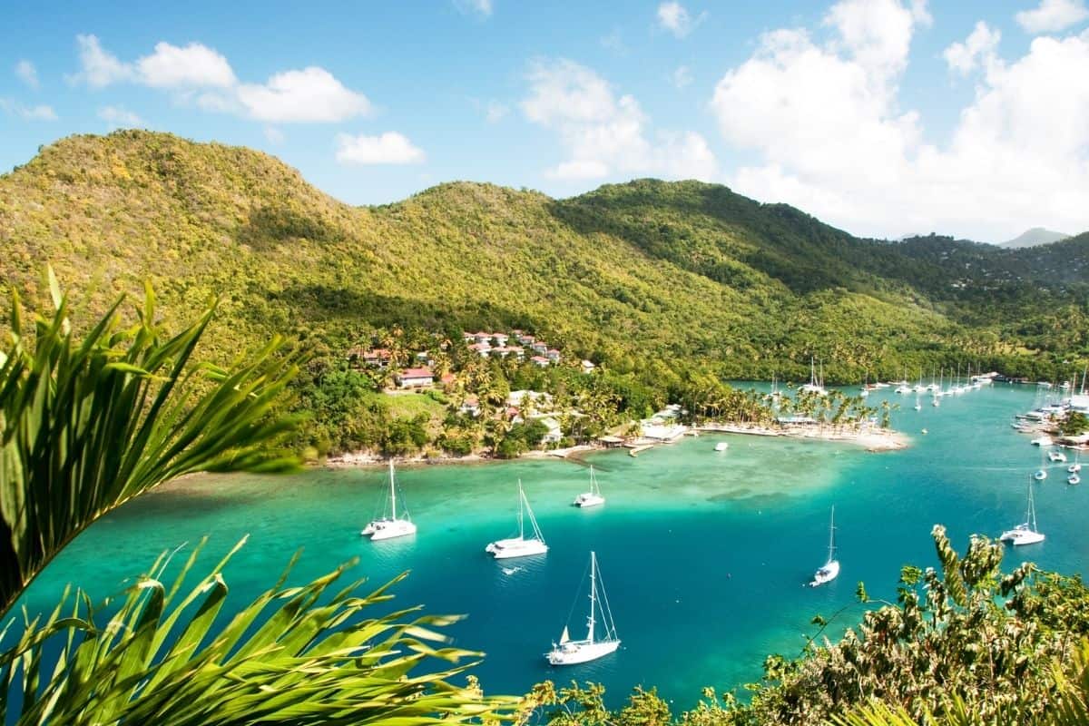 Aerial view of sailboats anchored in the turquoise waters of Marigot Bay.
