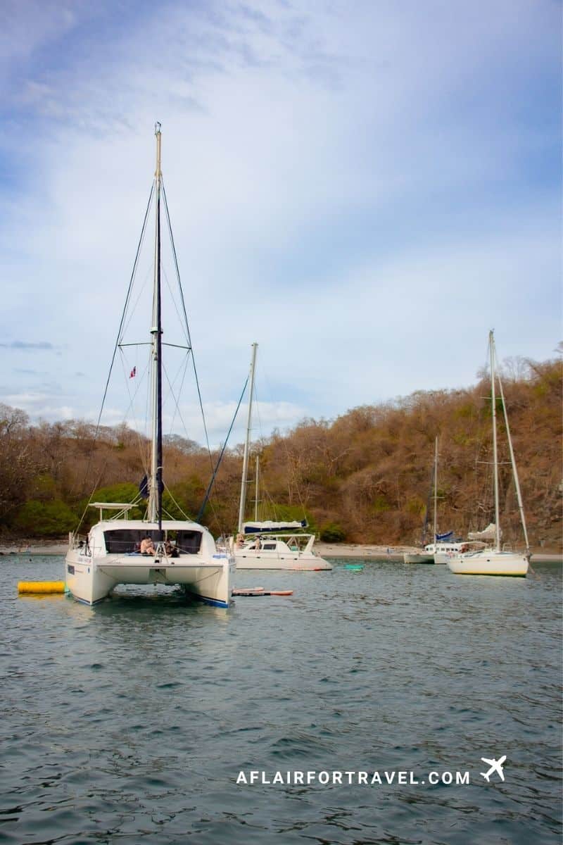 Catamaran and sailboats anchored in a Guanacaste bay, a full-day excursion that can shape how many days you need in Costa Rica
